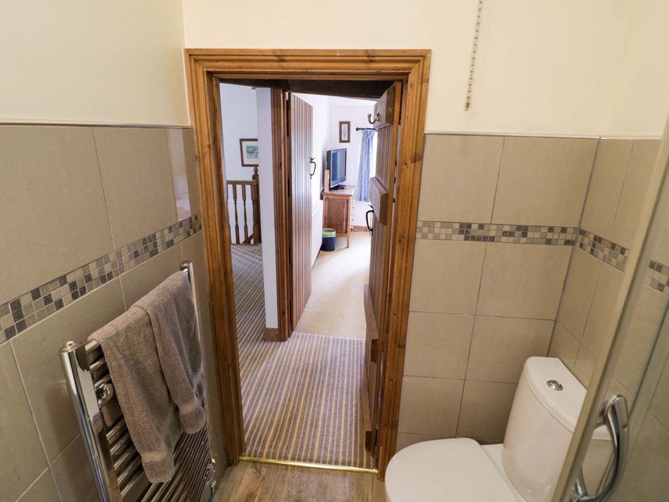 A bathroom with a toilet and towel at Elmhurst Cottage in Lower Quinton