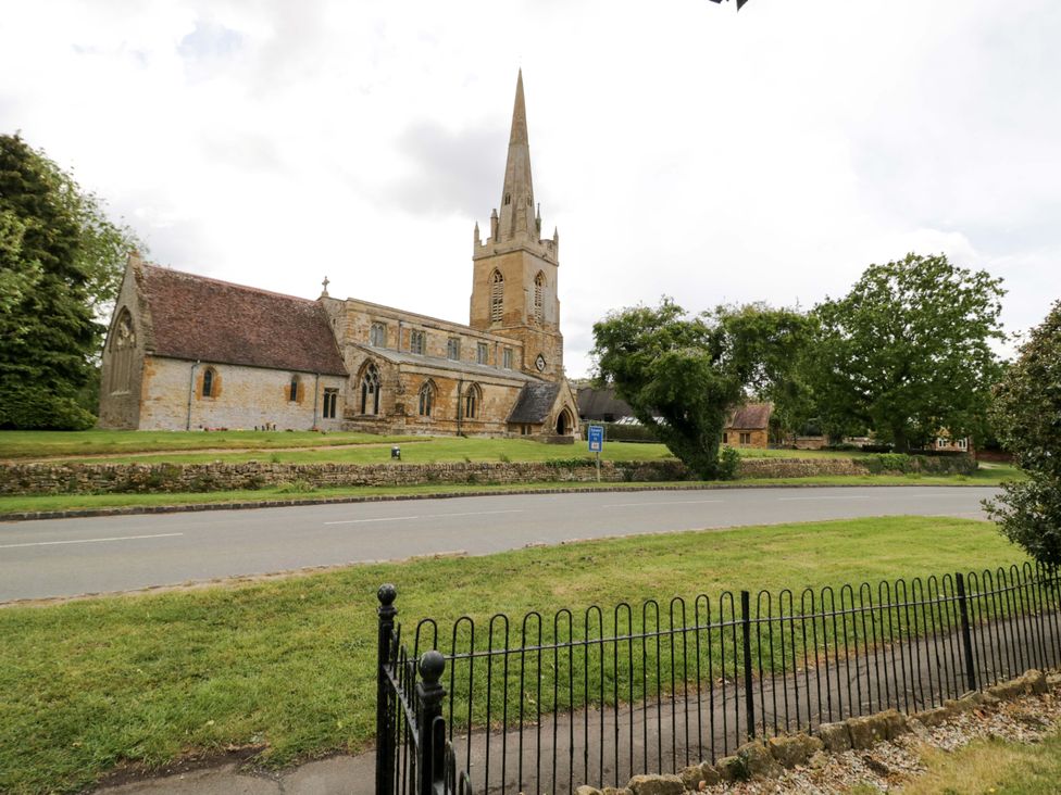 A church building with a steeple near a road at Elmhurst Cottage in Lower Quinton