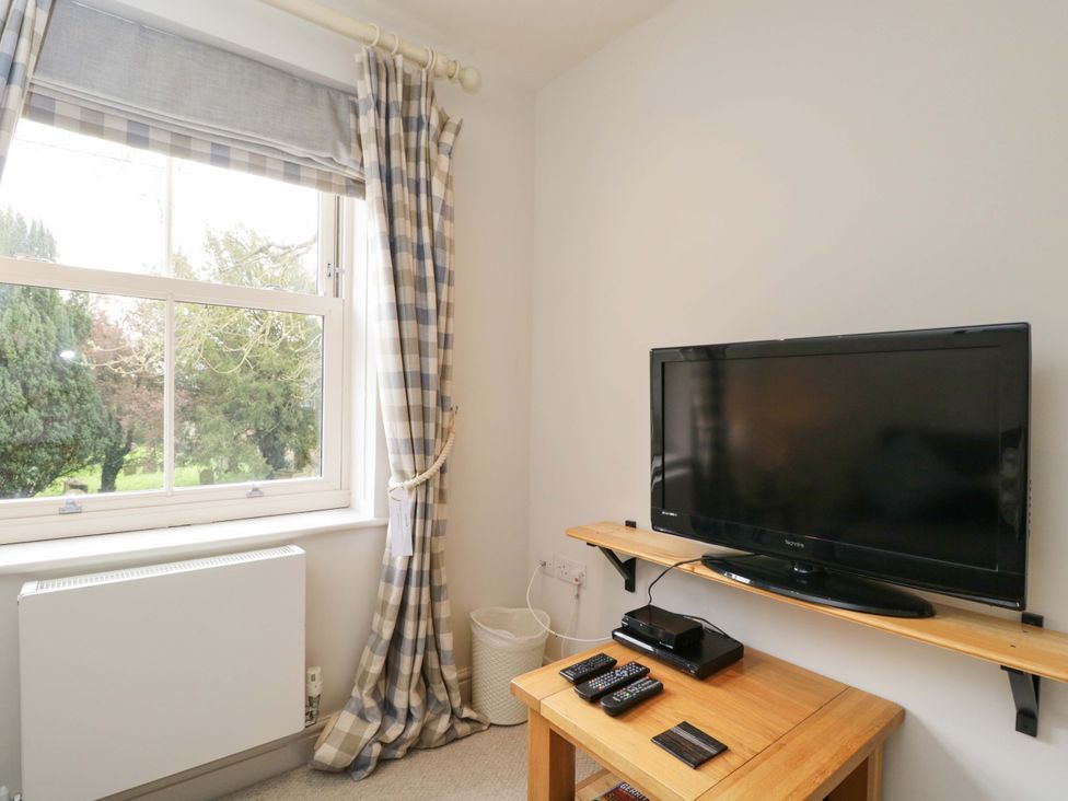 A living room with a television and window at Church View in Bourton-On-The-Water