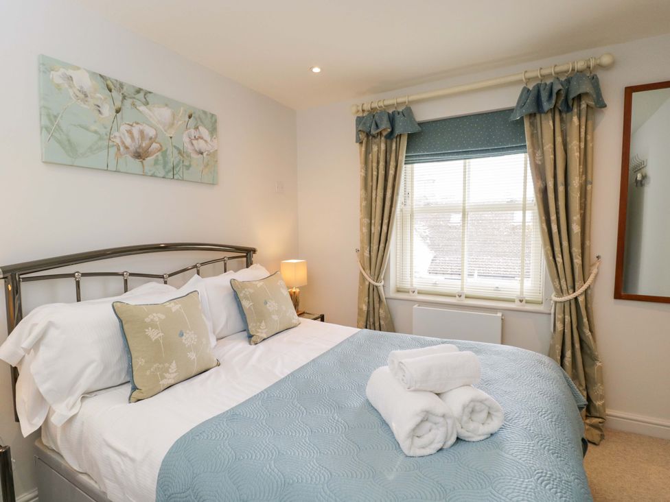 A bedroom with a double bed and bedside lamp at Church View in Bourton-On-The-Water