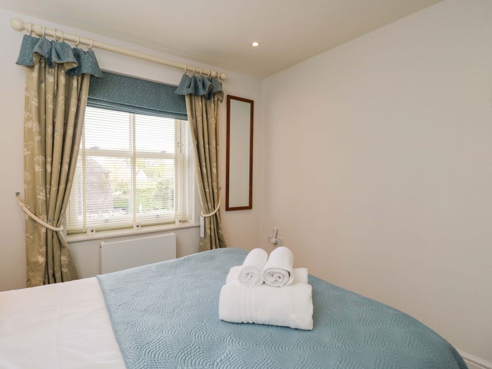 A bedroom with a bed and towels on it at Church View in Bourton-On-The-Water