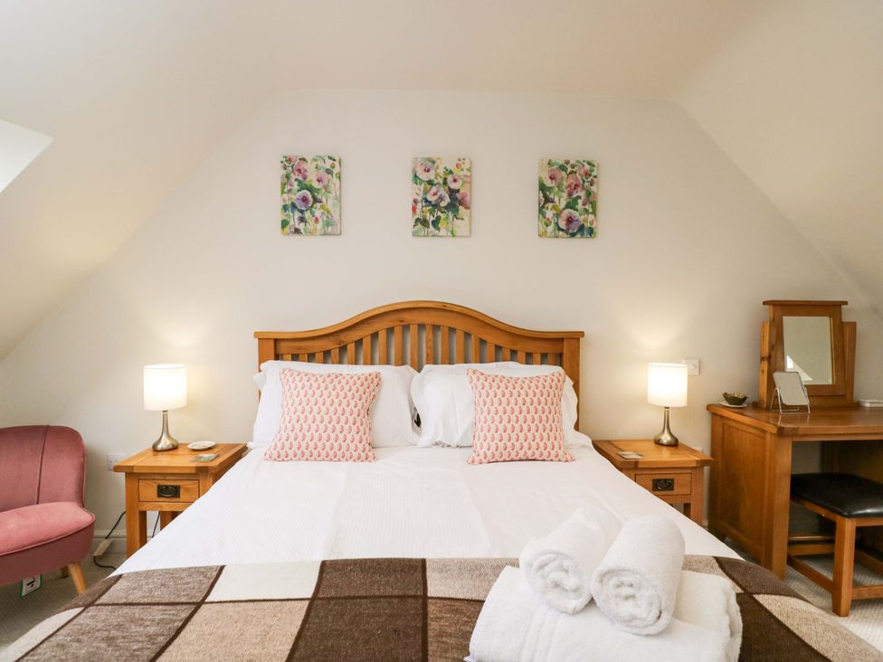 A bedroom with a bed and a desk at Church View in Bourton-On-The-Water