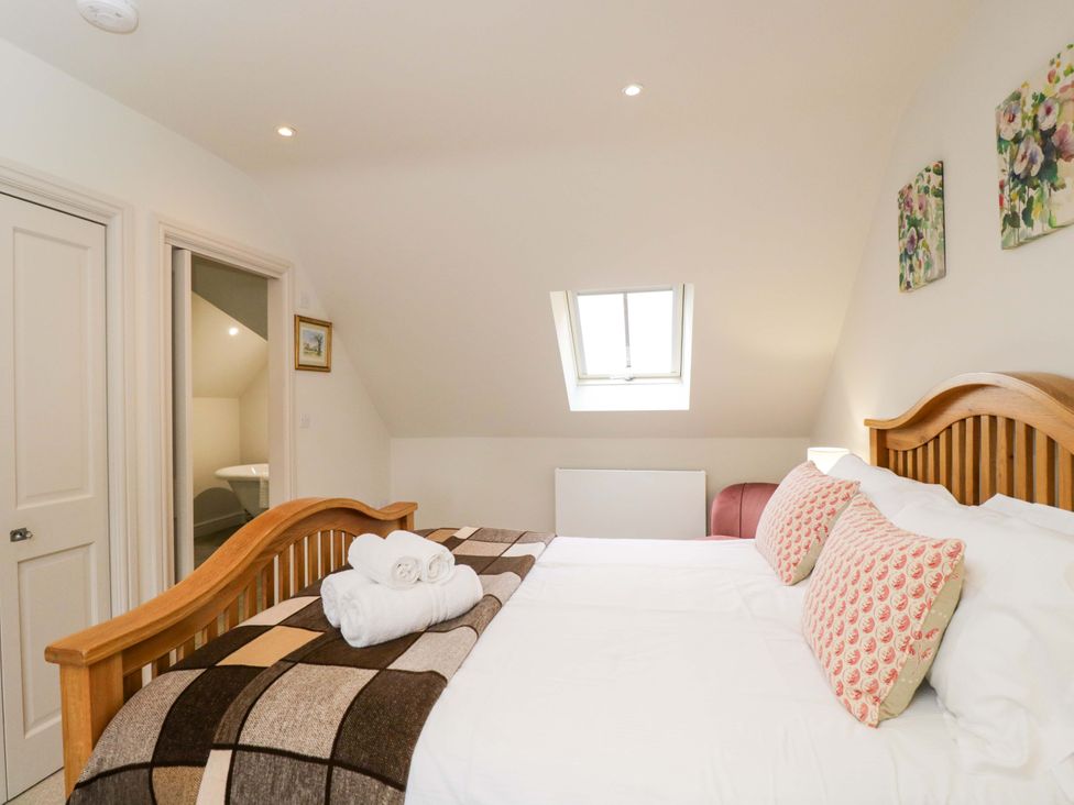 A bedroom with a bed and artwork at Church View in Bourton-On-The-Water