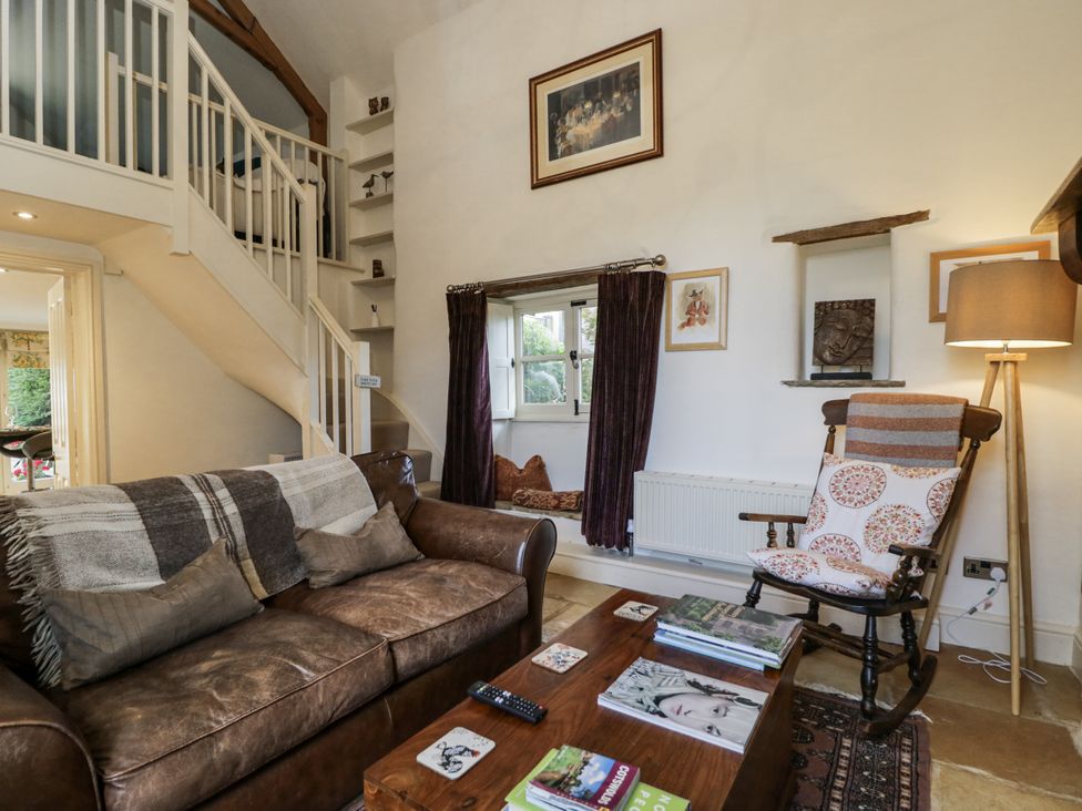 A living room with a sofa and coffee table at The Old Reading Room in Bledington near Stow-on-the-Wold