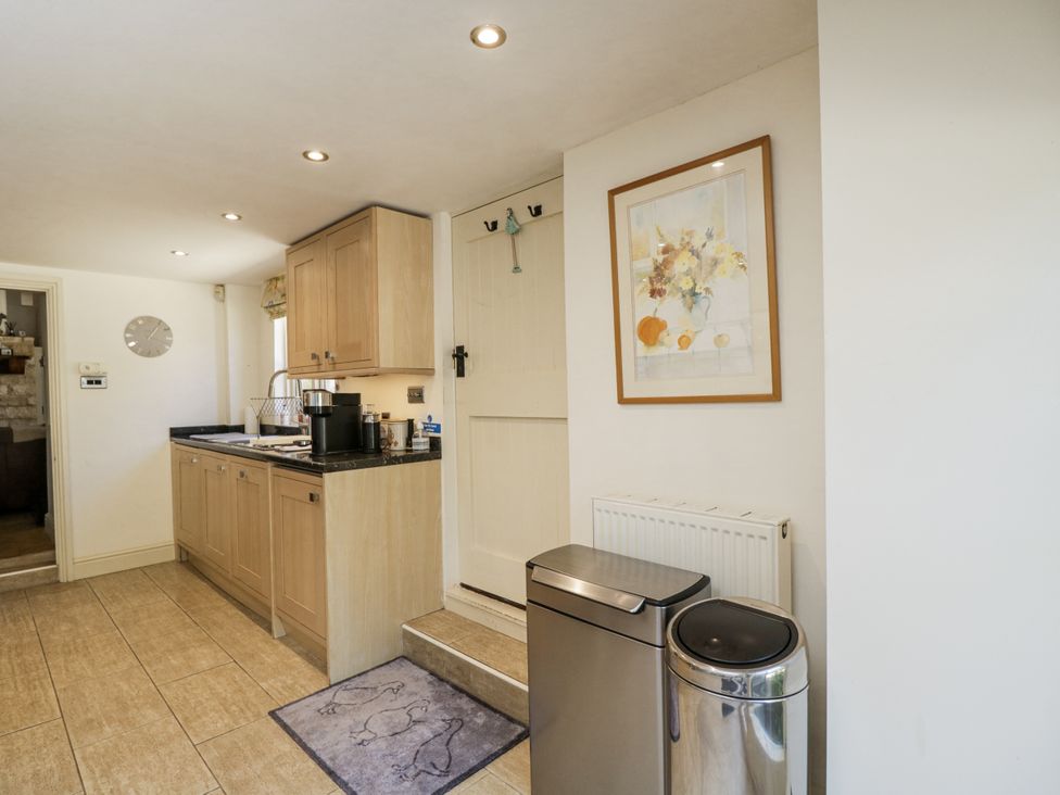 A kitchen with cabinets and a sink at The Old Reading Room in Bledington near Stow-on-the-Wold