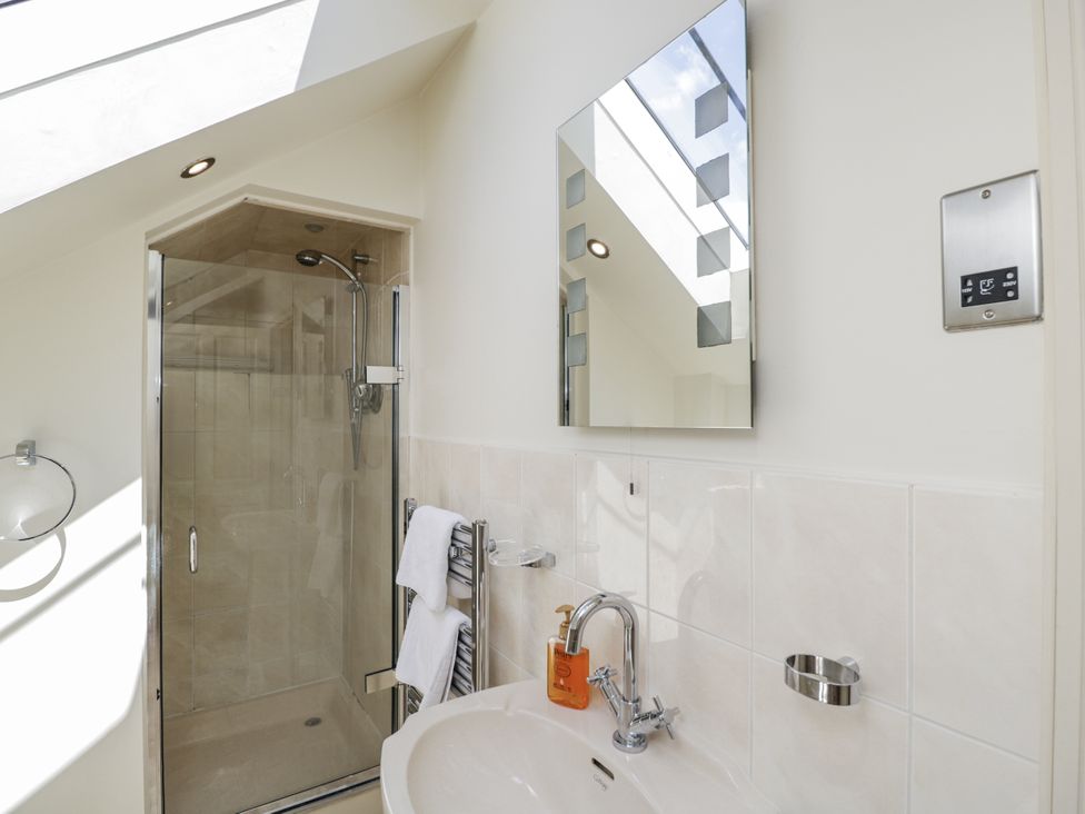 A bathroom with a shower and sink at The Old Reading Room Bledington near Stow-on-the-Wold