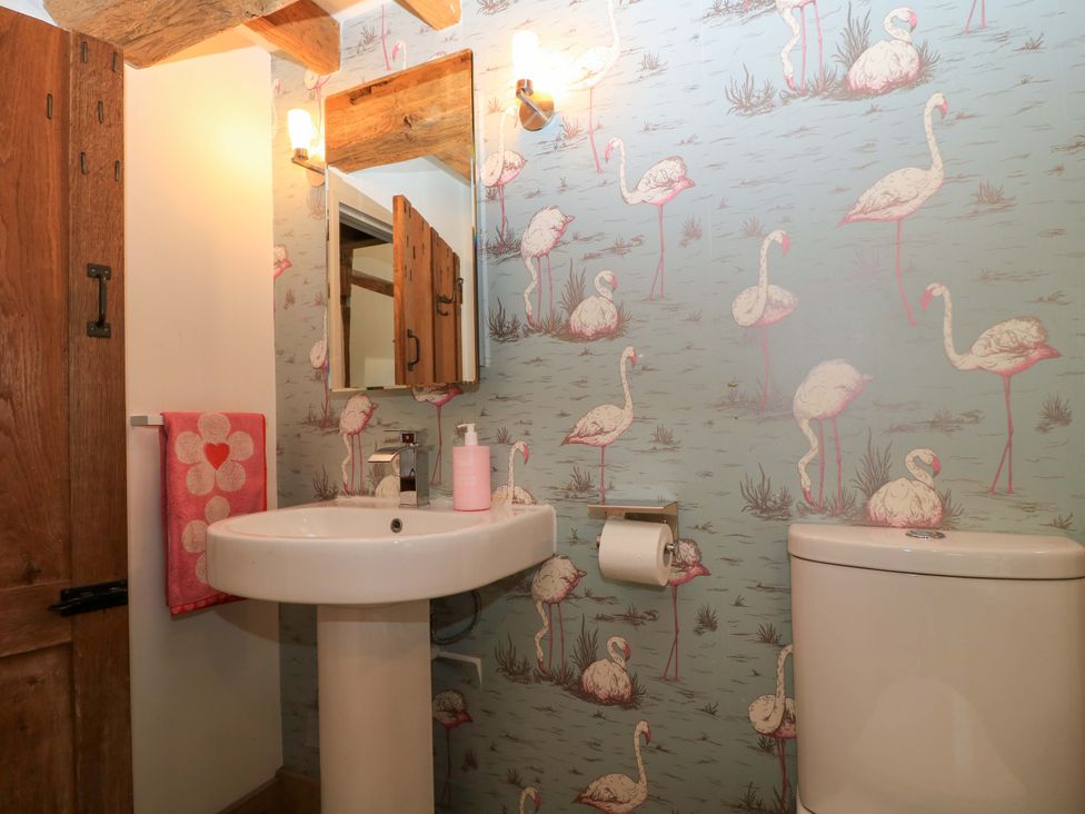 A bathroom with a sink and toilet at The Linhay near Little Coxwell