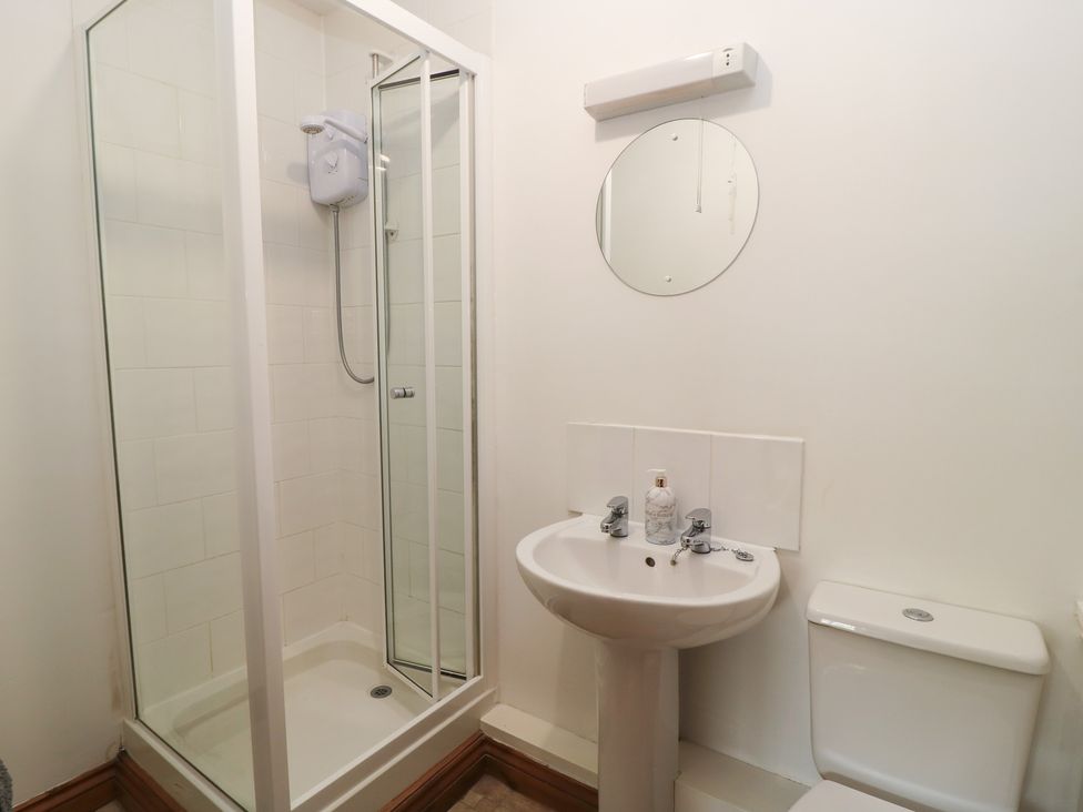 A bathroom with a shower, toilet and sink at Tithe Barn, Lyneham