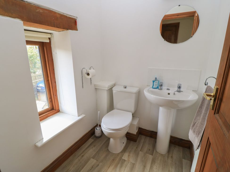 A bathroom with a toilet and sink at Tithe Barn, Lyneham