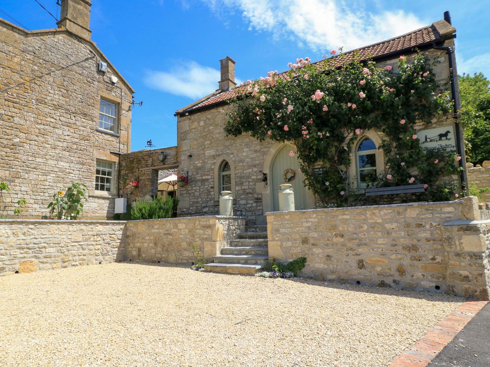 An outdoor view of a stone cottage with a garden at Cider Press Cottage in Priston Village, Bath