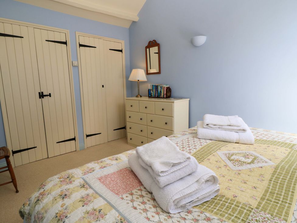 A bedroom with a bed and a dresser at Cider Press Cottage, Priston Village, Bath