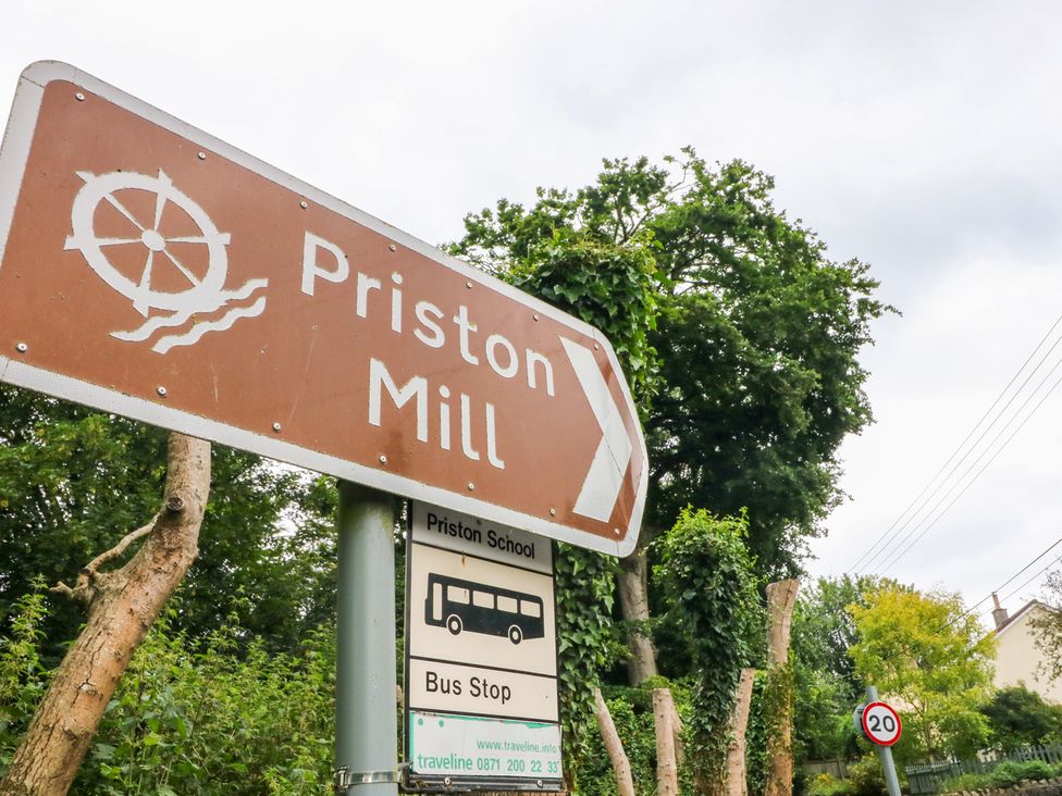 A sign for Priston Mill and bus stop in Priston Village, Bath