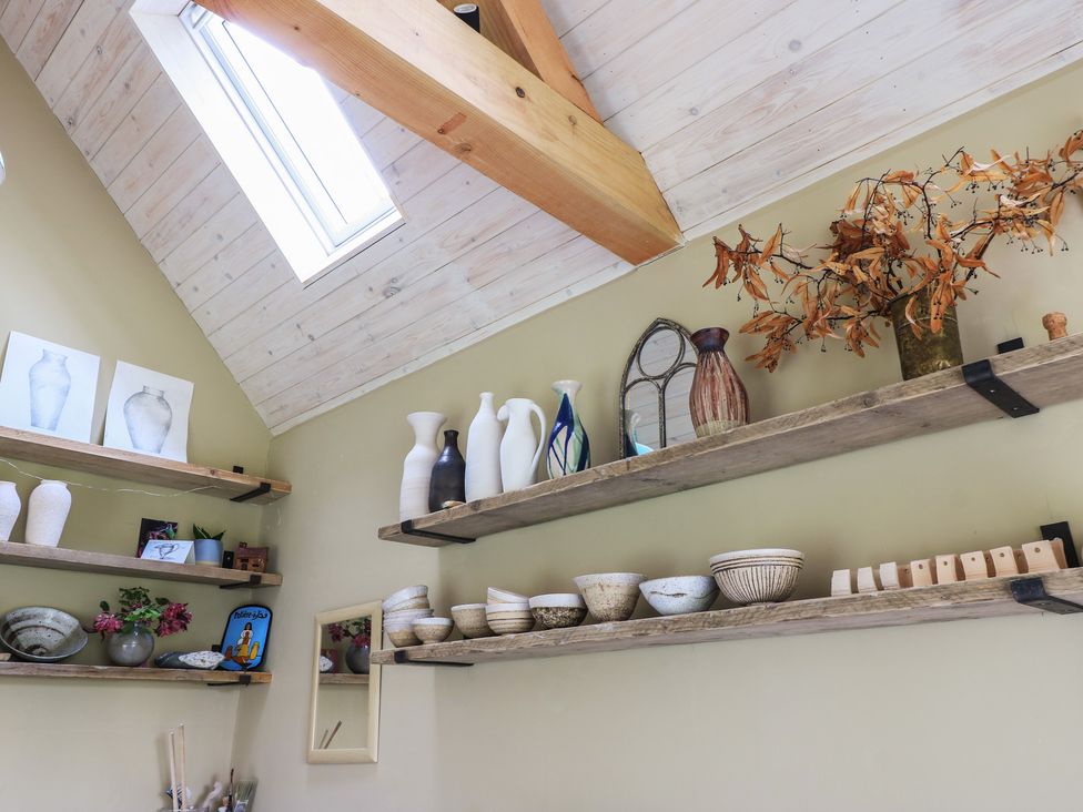 A collection of vases and bowls on shelves in a room at Bridge Studio near Broad Chalke