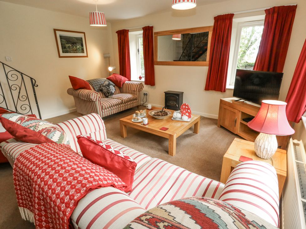 A living room with a sofa and television at Droop Farm Cottage in Droop near Hazelbury Bryan