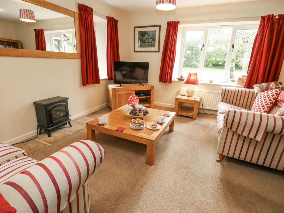 A living room with a sofa and coffee table at Droop Farm Cottage, Droop near Hazelbury Bryan