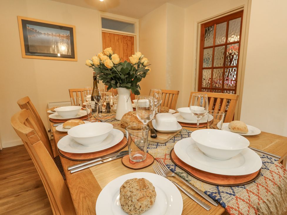 A dining room with a table set for a meal at Droop Farm Cottage Droop near Hazelbury Bryan