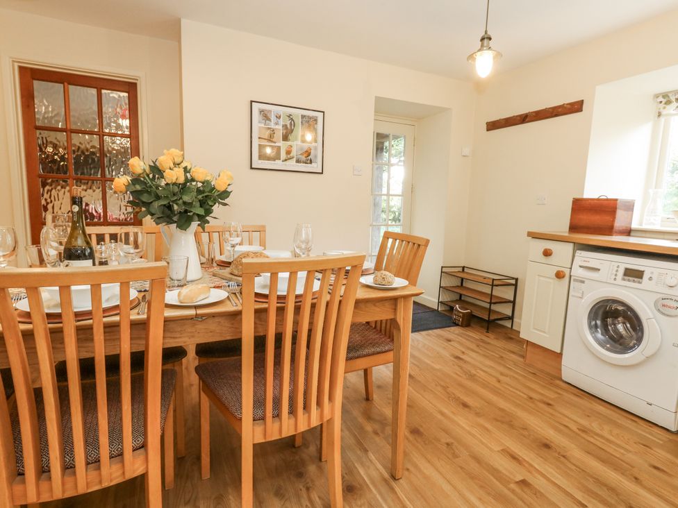 A dining room with a table set for a meal at Droop Farm Cottage Droop near Hazelbury Bryan