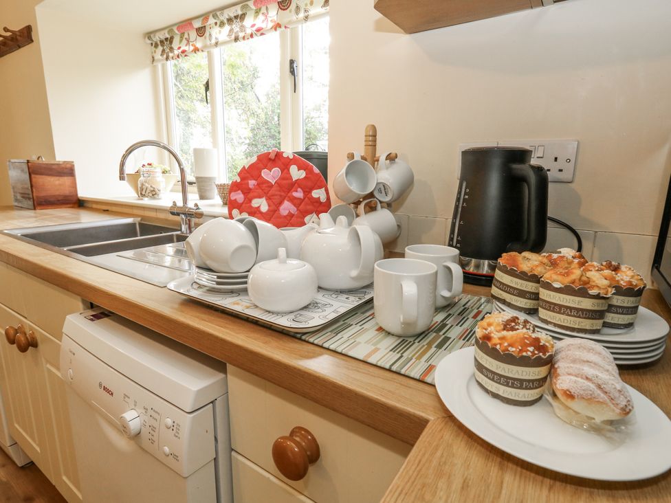 A kitchen with a sink and various kitchenware at Droop Farm Cottage Droop near Hazelbury Bryan