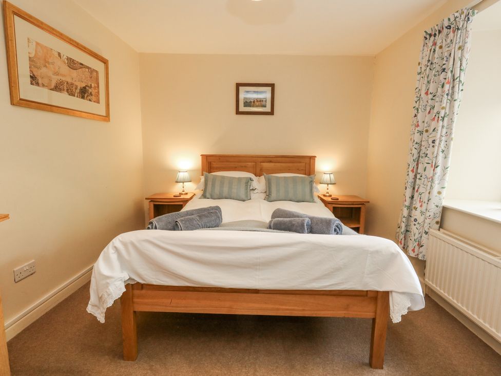 A bedroom with a bed and nightstands at Droop Farm Cottage Droop near Hazelbury Bryan
