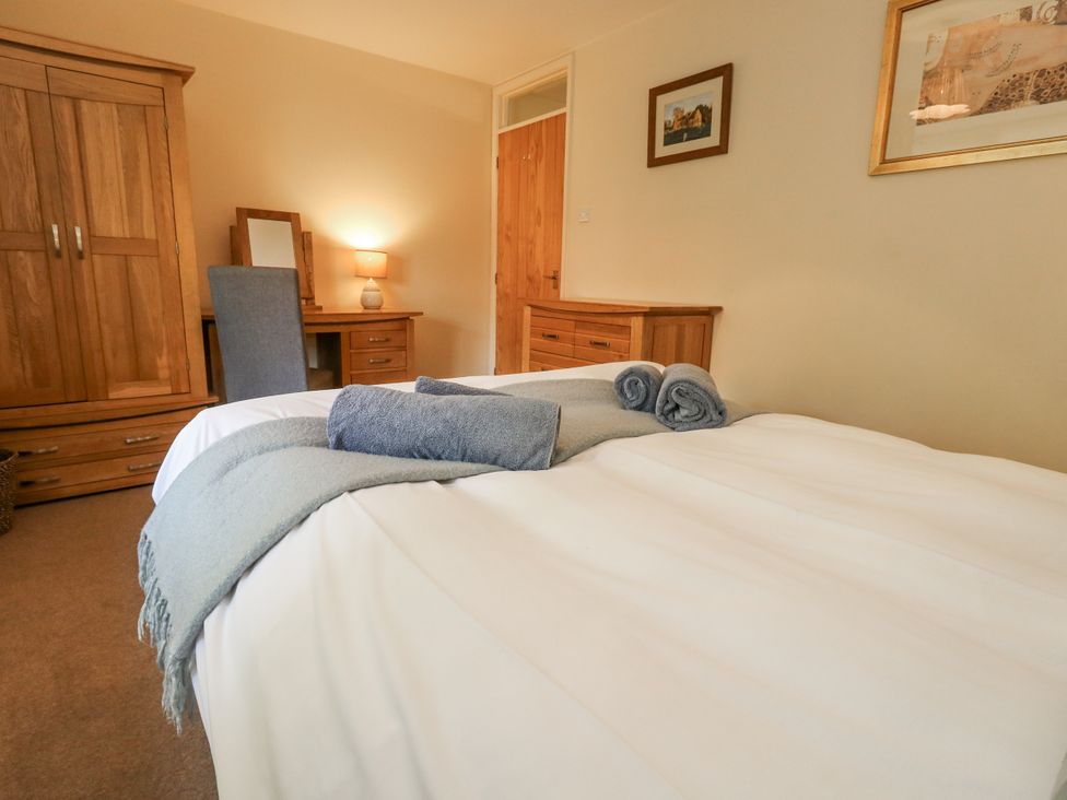 A bedroom with a bed and wooden furniture at Droop Farm Cottage Droop near Hazelbury Bryan