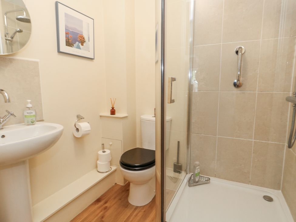 A bathroom with a sink, toilet, and shower at Droop Farm Cottage Droop near Hazelbury Bryan
