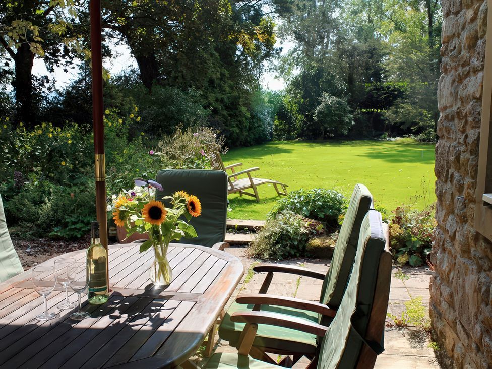 A garden with a table and chairs at Droop Farm Cottage in Droop near Hazelbury Bryan