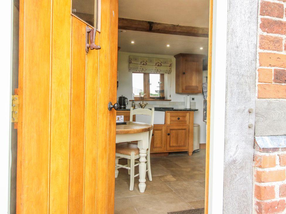 A kitchen with a table and chairs visible from the doorway at The Shooting Folly in Cheswardine