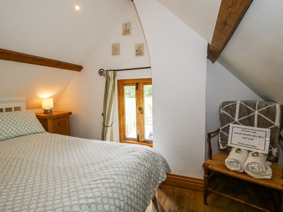 A bedroom with a bed and a window at The Shooting Folly in Cheswardine