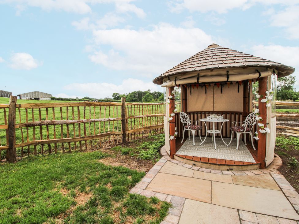 A gazebo with a table and chairs in an outdoor space at The Shooting Folly in Cheswardine