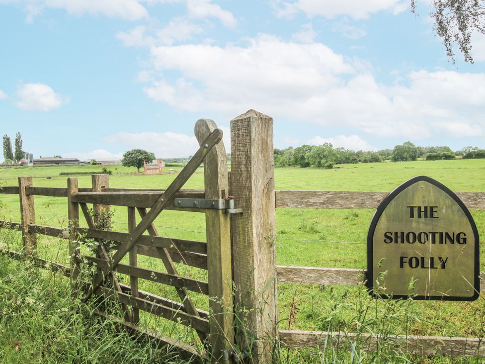 A wooden gate with a sign at The Shooting Folly in Cheswardine