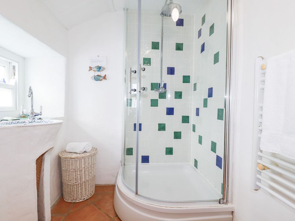 A bathroom with a shower and sink at Greeb Rocks Cottage in Marazion