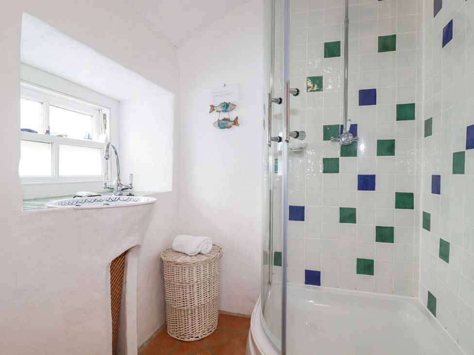 A bathroom with a shower and sink at Greeb Rocks Cottage, Marazion