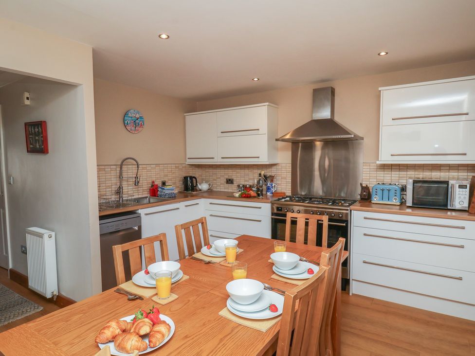 A kitchen with a dining table set for breakfast at Haven House in Whitby