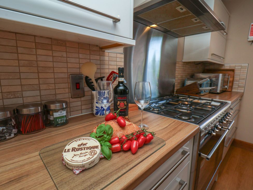 A kitchen with cooking utensils and food items at Haven House in Whitby