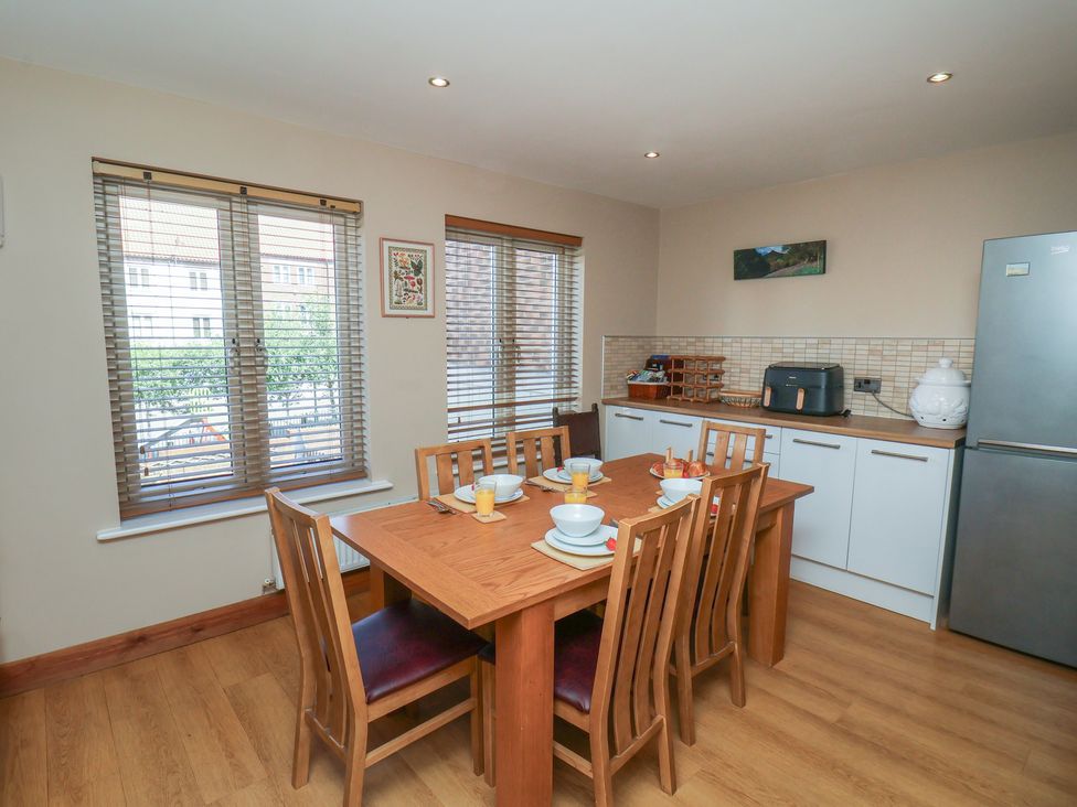 A kitchen with a dining table and chairs at Haven House in Whitby