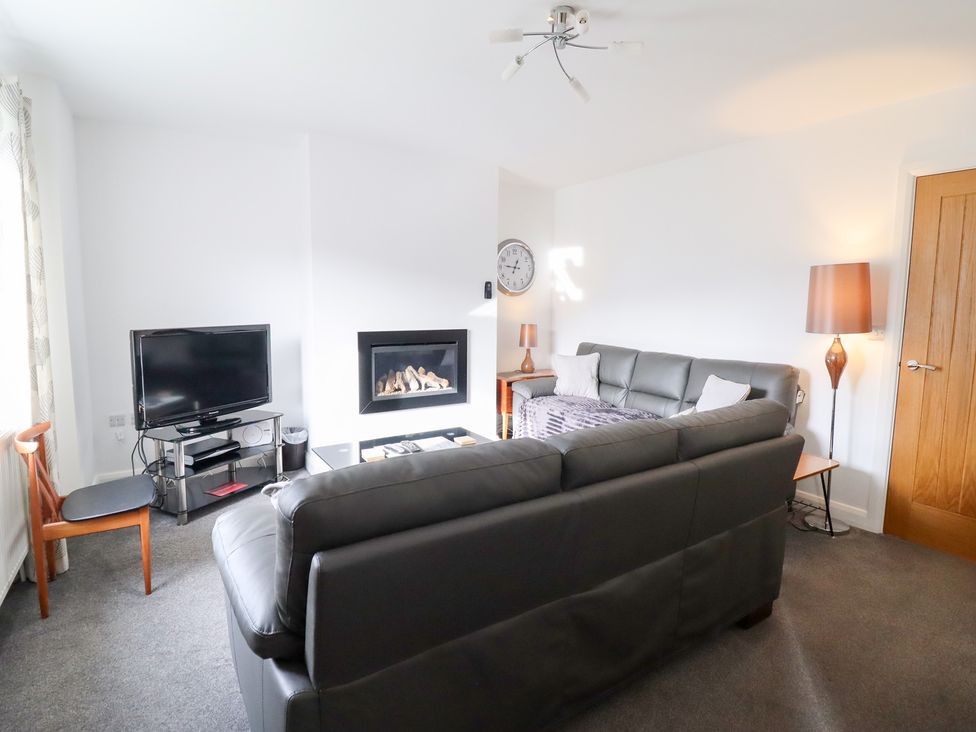 A living room with a television and fireplace at Arnant in Dolgellau