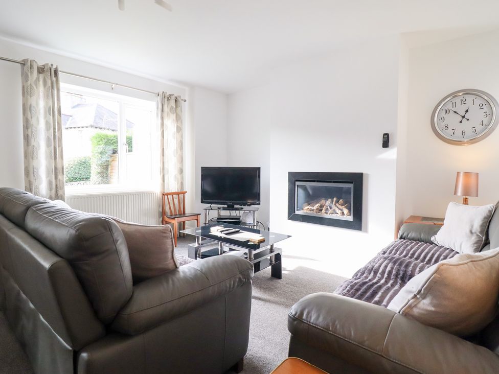 A living room with a television and fireplace at Arnant in Dolgellau