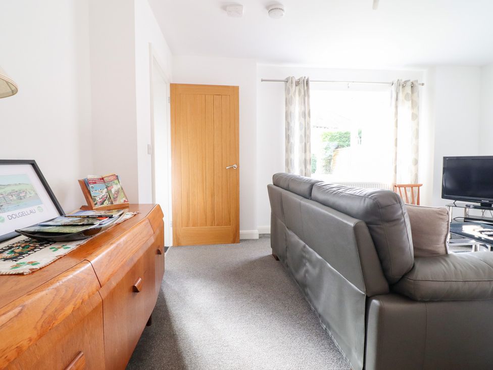 A living room with a sofa and television at Arnant in Dolgellau