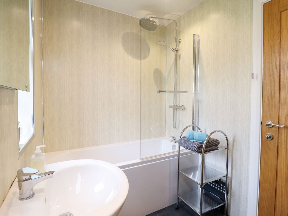 A bathroom with a bath tub and shower at Arnant in Dolgellau