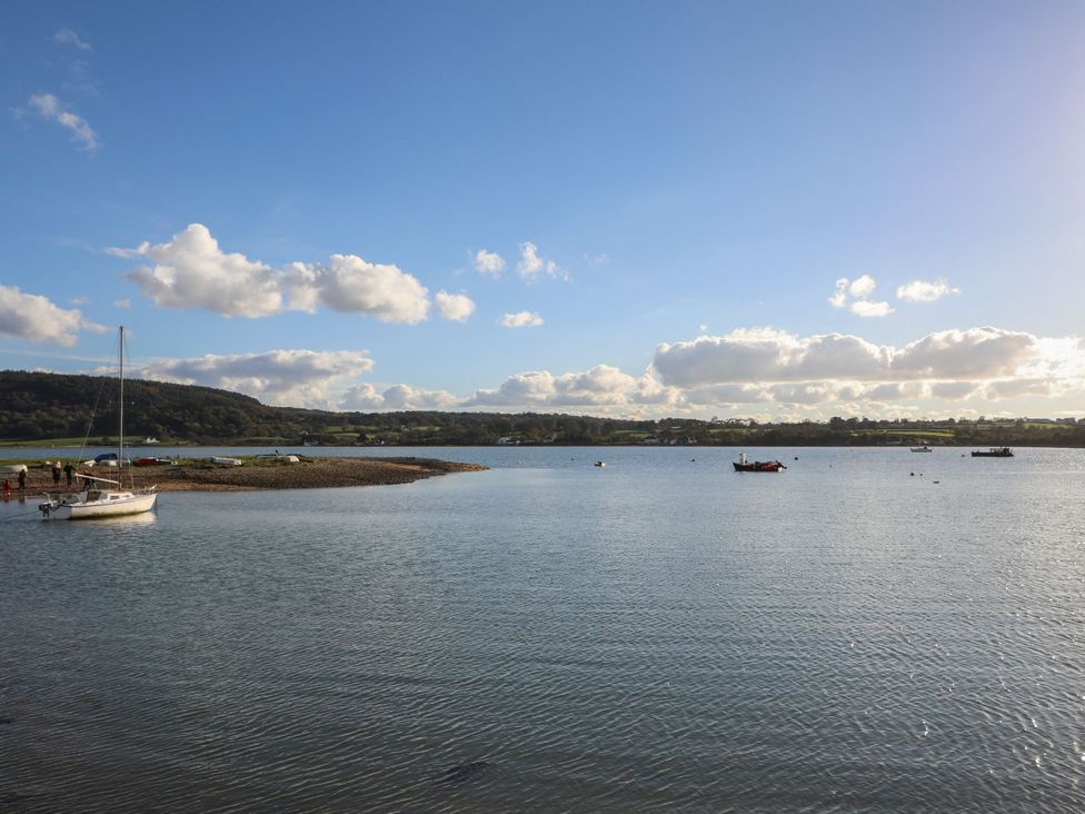 A view of boats on water with hills and clouds at Hen Hafod in Talwrn near Llangefni