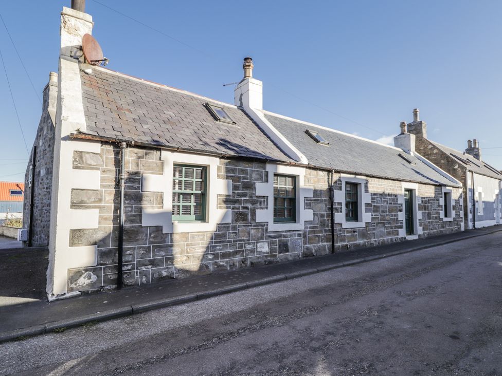 A stone building with a slate roof on a street at 83 Seatown in Cullen