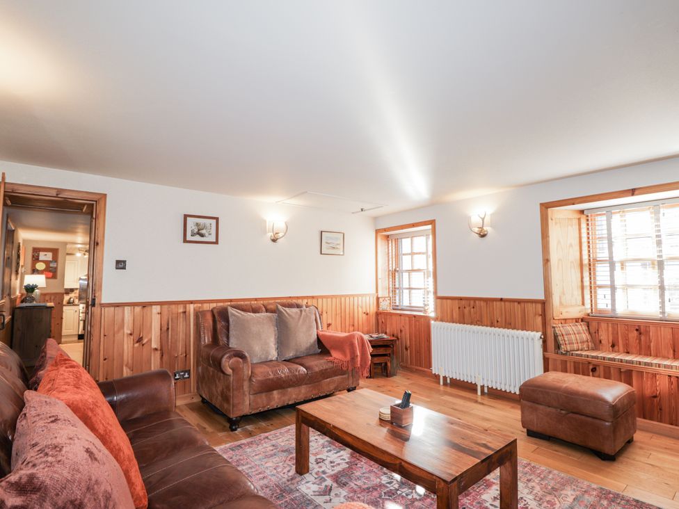 A living room with a sofa and table at 83 Seatown, Cullen