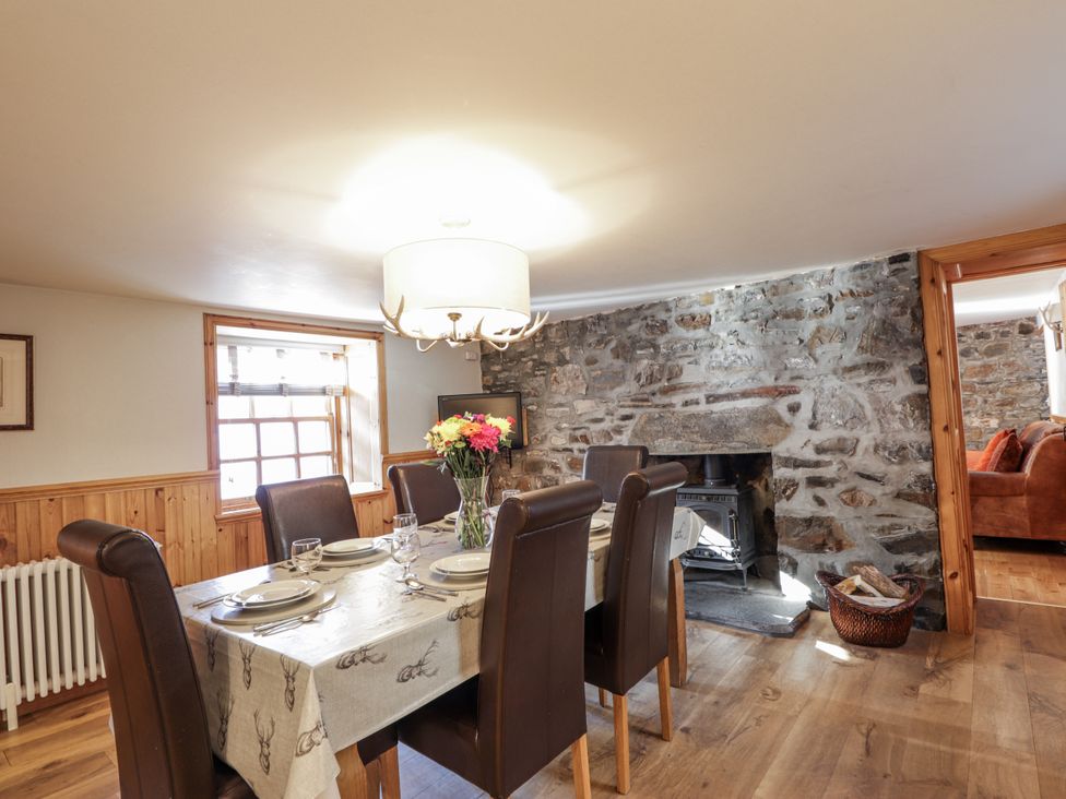 A dining room with a table and chairs at 83 Seatown in Cullen