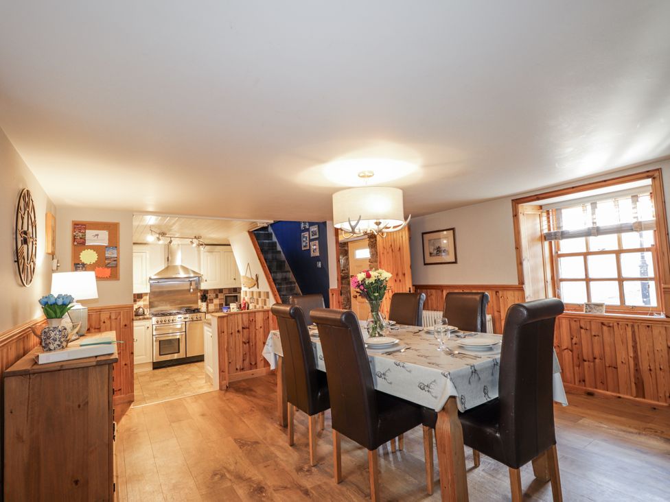 A dining room with table and chairs at 83 Seatown, Cullen