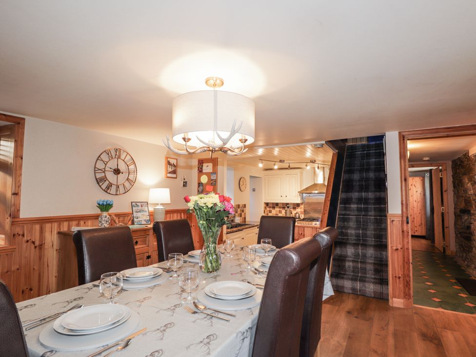 A dining room with a table set for meals at 83 Seatown, Cullen