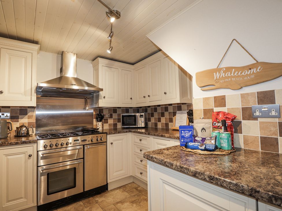 A kitchen with cabinets and stainless steel appliances at 83 Seatown in Cullen