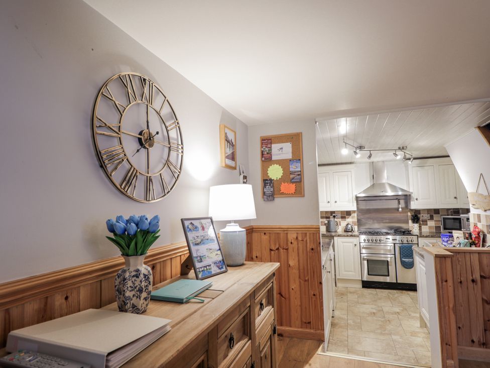 A kitchen with a clock, lamp, and flowers at 83 Seatown, Cullen