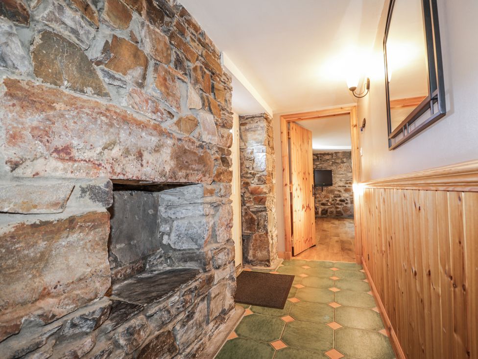 A hallway with stone walls and a door at 83 Seatown in Cullen