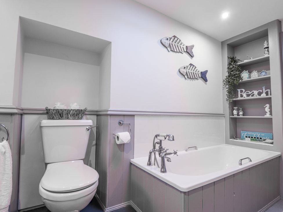 A bathroom with a toilet and a bath tub at 83 Seatown, Cullen