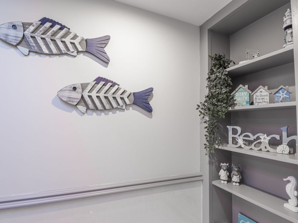 Decorative fish and shelf with items in an unspecified room at 83 Seatown, Cullen
